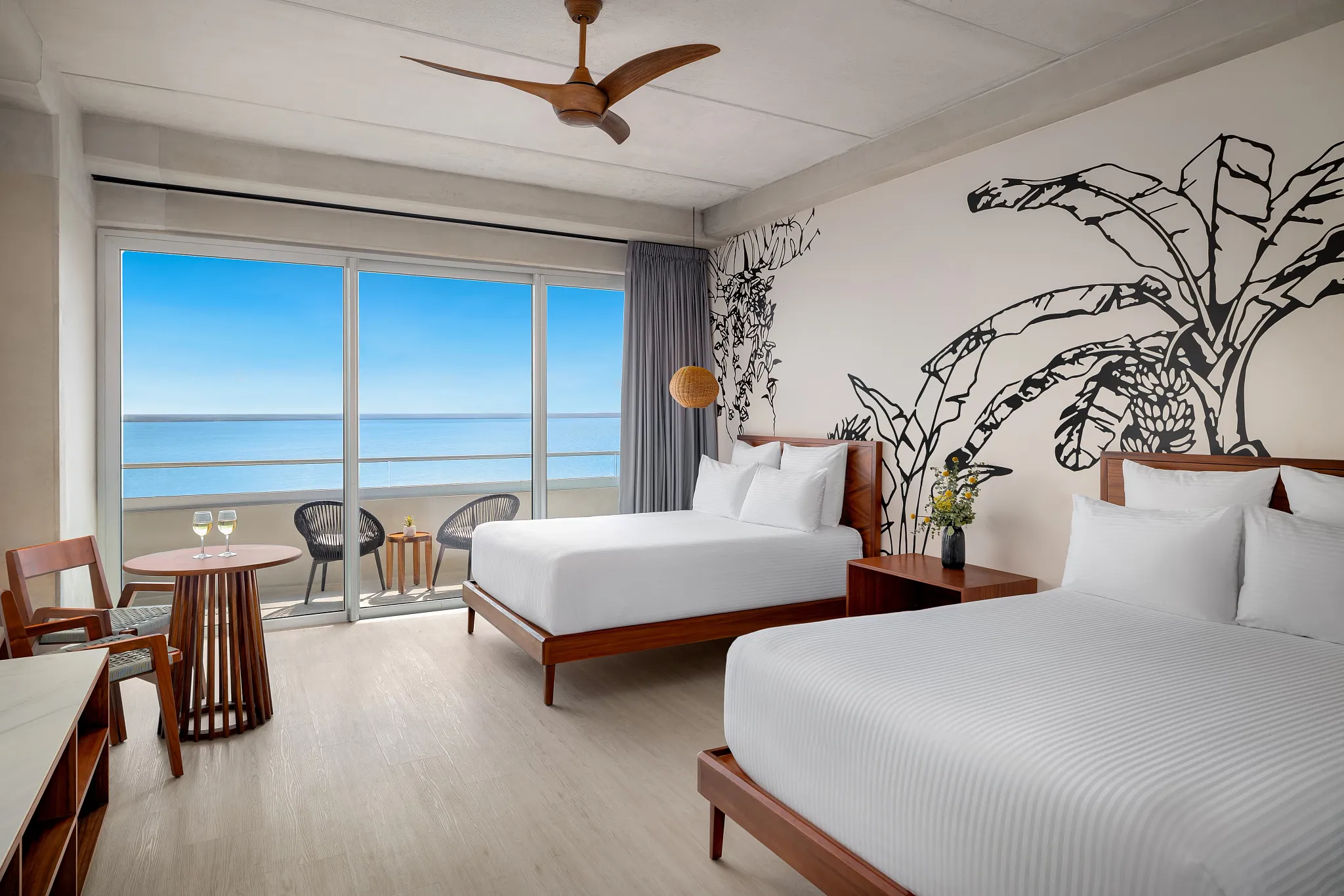 Junior Deluxe Suite Bay View with two double beds and private balcony overlooking the bay at Hyatt Vivid Grand Island.