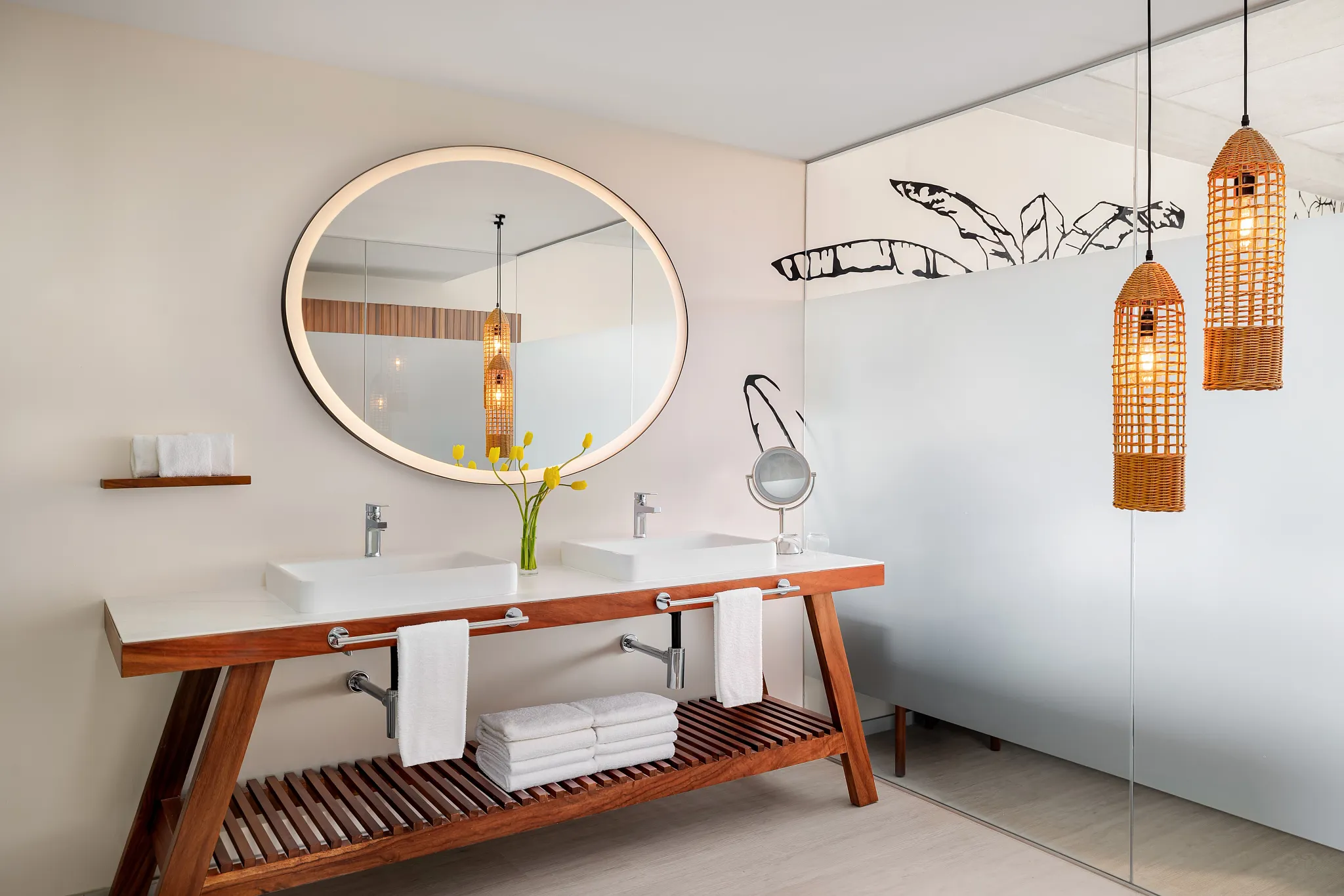 Junior Suite Golf View bathroom with double vanities, illuminated round mirror, and walk-in shower at Hyatt Vivid Grand Island.
