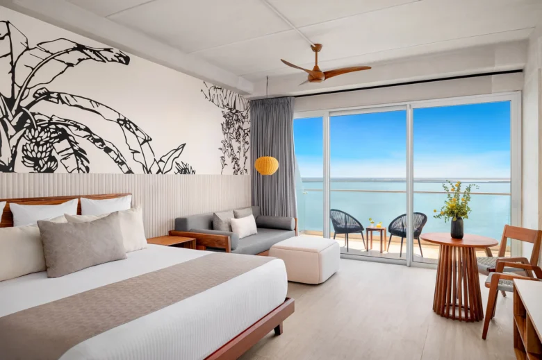 Vantage Club Junior Suite Bay View with king bed, seating area, and private balcony overlooking the bay at Hyatt Vivid Grand Island.